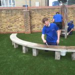 Bow Maintenance and Landscapes workers, adding finishing touches to Story time bench.