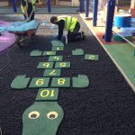 Creating fun images in the Saftey surfacing at Meath Gardens Children Center-min