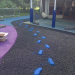 Creating fun patterens for the children in the safety surfacing at Meath Gardens Childrens Centre-min