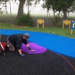 Safety surfacing in the process of being laid at Meath Gardens Childrens center by workers of Bow Maintenance and Landscaping-min