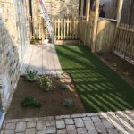 redesign of small outdoor space by Bow Maintenance and Landscaping, by laying atrifical grass and creating small beding area.